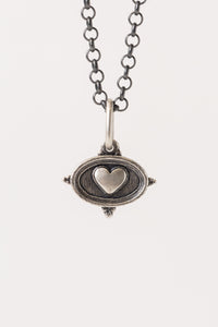 Erica Molinari small fine jewelry Sterling Silver oval dual-sided pendant with a heart shape embossed on the front, and an inscription of the word for love ("AMOR") engraved on the back