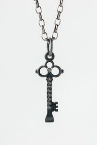 Erica Molinari oxidized sterling silver fine jewelry skeleton key pendant with round circle cut details and white diamonds throughout